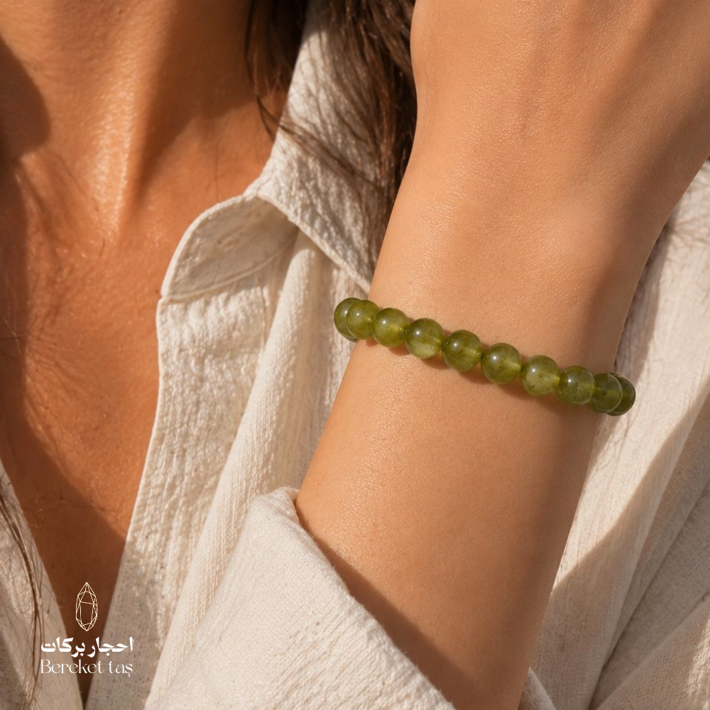 Natural Peridot stone bracelet with green 6 mm beads worn on the wrist