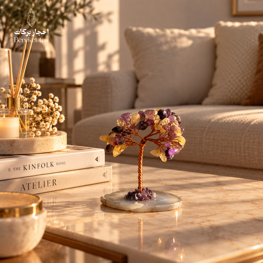 Citrine and Amethyst gemstone tree with a natural Agate base displayed on a marble coffee table