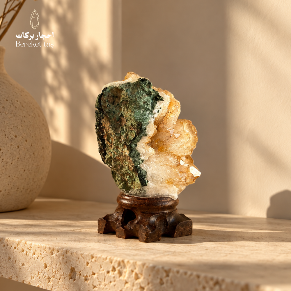 Natural Citrine crystal with green mineral matrix displayed on a carved wooden stand