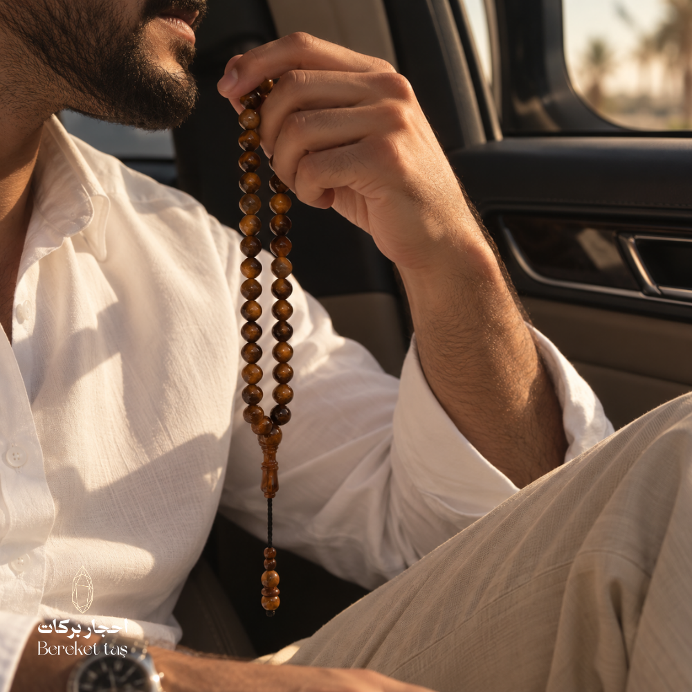 Natural Kuka Prayer Beads held in hand inside a car, featuring polished brown beads in rich natural tones