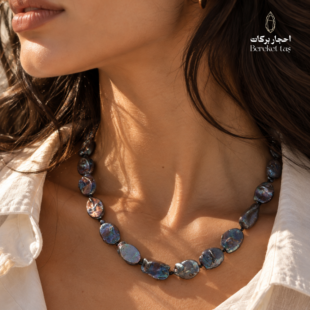Close-up of a natural gray Pearl handmade necklace highlighting the irregular beads and blue iridescent reflections