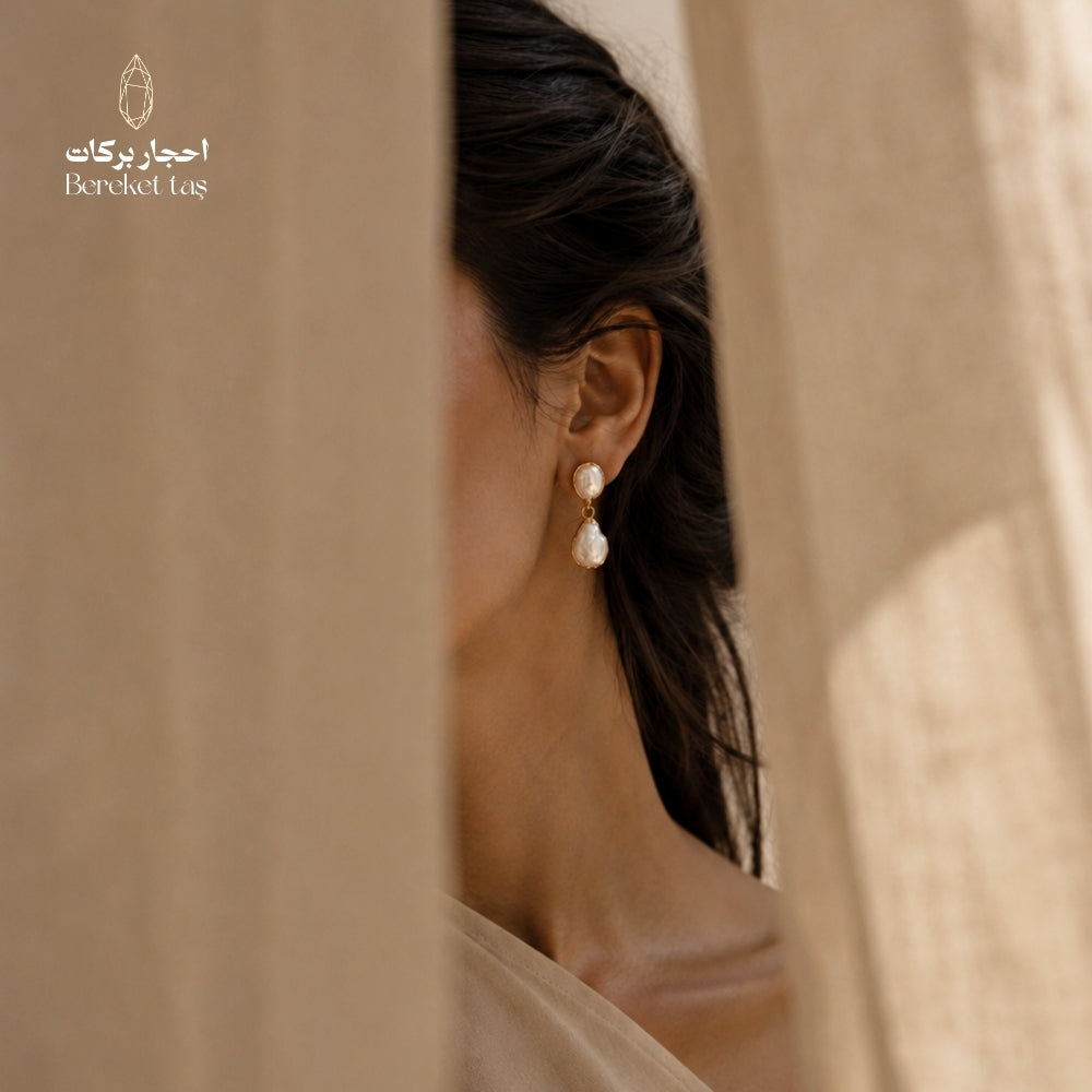 Natural Pearl drop earring with gold-plated metal featured in an elegant portrait