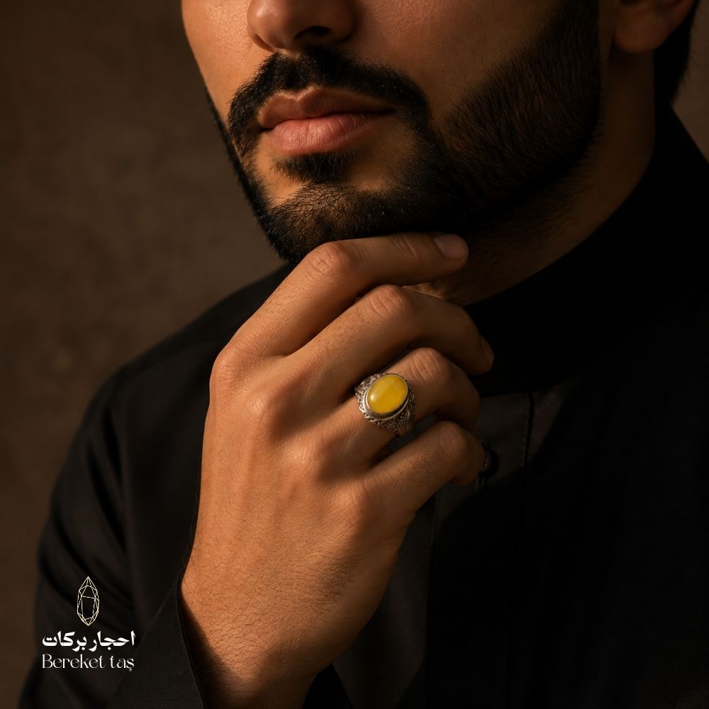 Natural yellow amber ring set in 925 sterling silver, worn on hand.