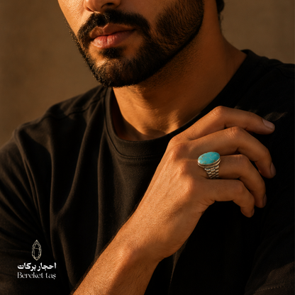 Iranian Nishapur turquoise ring in 925 sterling silver worn on a hand, showcasing its oval turquoise stone and detailed silver setting.