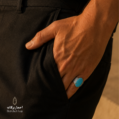 Iranian Nishapur turquoise ring in 925 sterling silver, shown in a close-up lifestyle photograph.