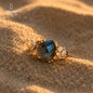 Natural Labradorite ring (Peacock Stone) on sand