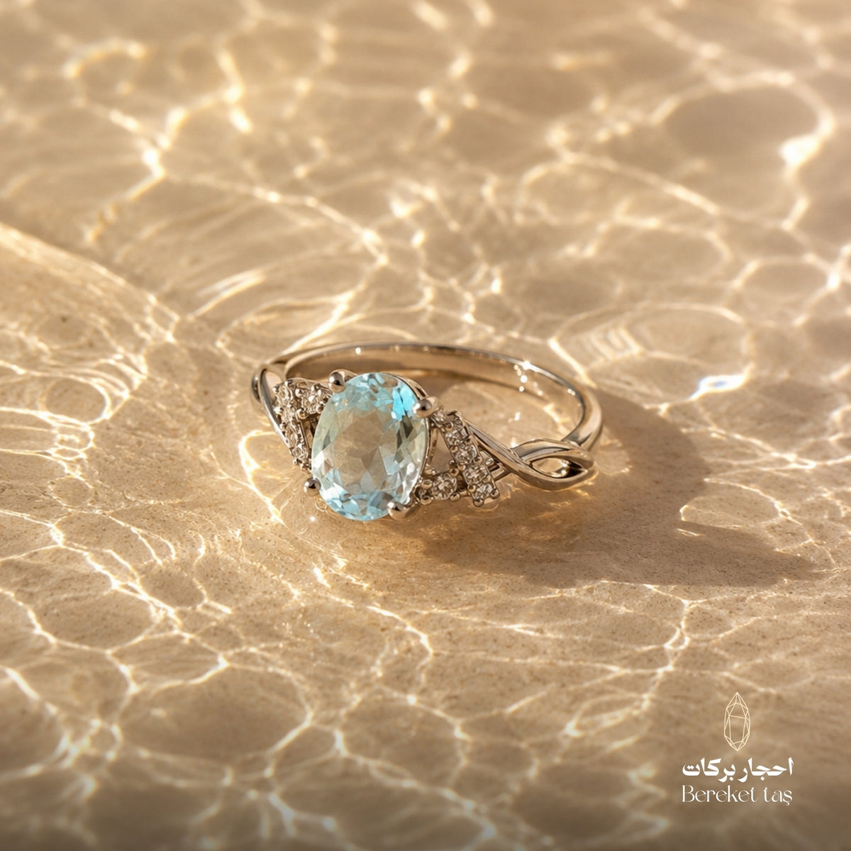 Natural aquamarine gemstone ring with a light blue oval stone on water