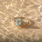 Natural aquamarine gemstone ring with a light blue oval stone on water