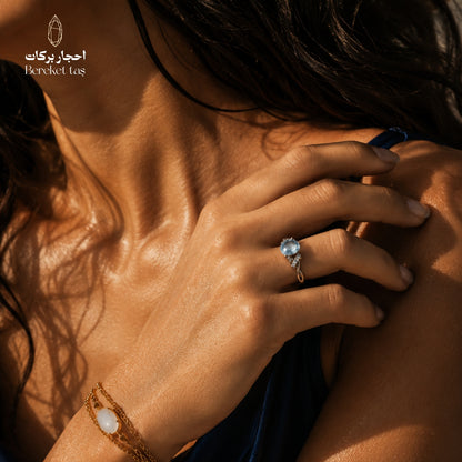 Natural aquamarine gemstone ring with a light blue stone worn on a woman's hand