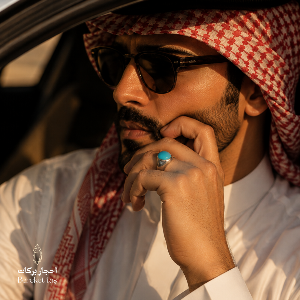 Nishapur Iranian turquoise sterling silver ring worn by a man in traditional Gulf attire, showcasing the vivid blue turquoise stone in warm natural light.