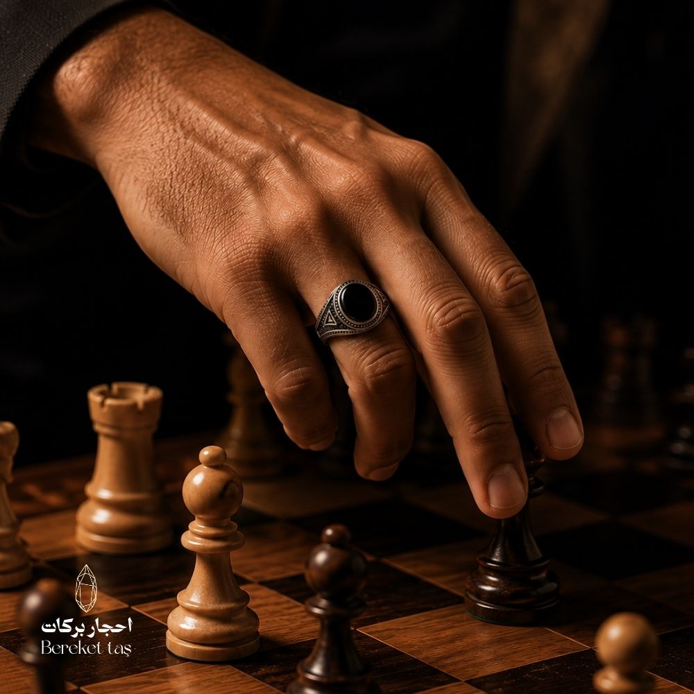 Luxury men’s Onyx stone ring in 925 sterling silver, worn on hand beside a chessboard — Bereket Taş