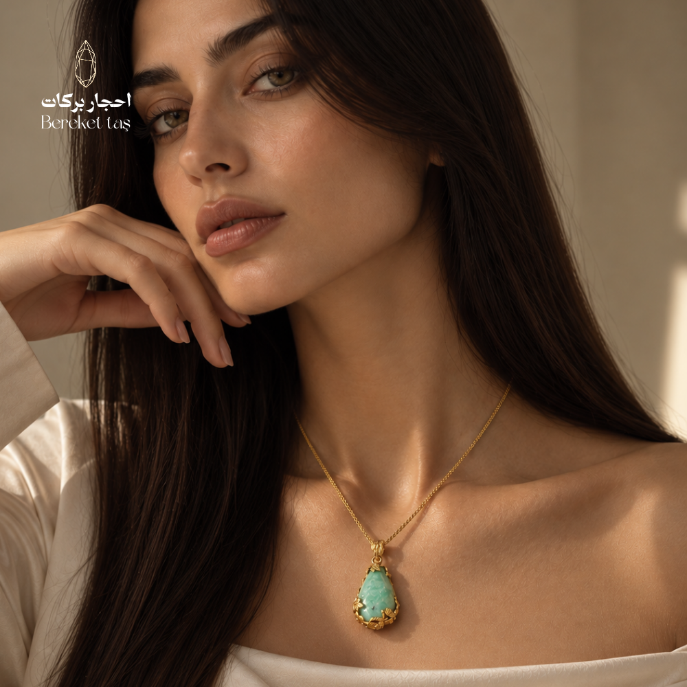Natural green Amazonite pendant necklace with a gold-plated chain worn with an elegant white outfit