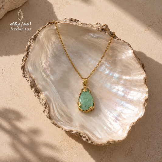 Natural green Amazonite pendant necklace with a gold-plated chain displayed on a pearl shell