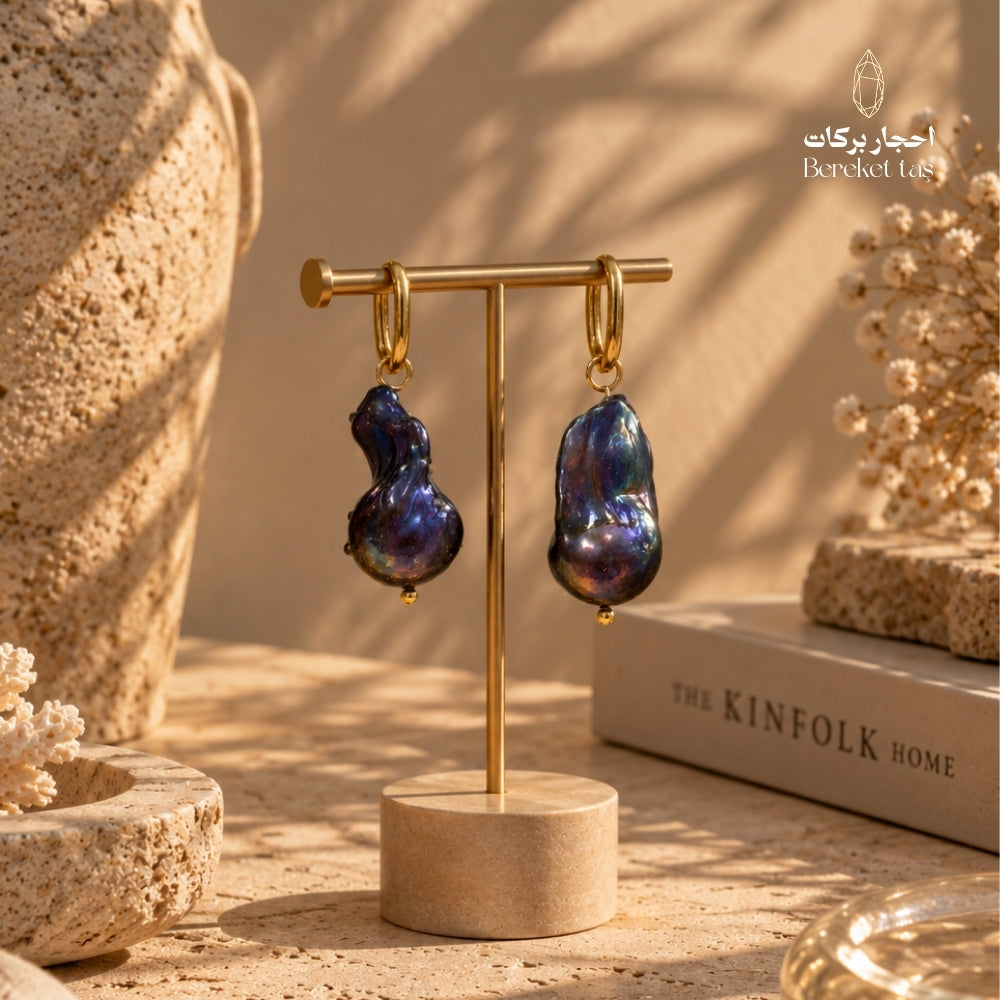 Natural Baroque Pearl earrings with gold-plated copper displayed on a jewelry stand in a warm luxury setting