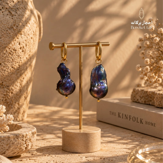 Natural Baroque Pearl earrings with gold-plated copper displayed on a jewelry stand in a warm luxury setting