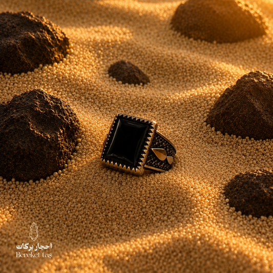 Black Onyx ring in 925 Sterling Silver placed on warm desert sand