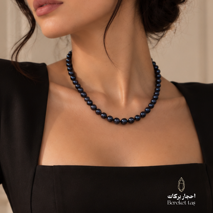 Natural black and deep navy Pearl necklace shown in a close-up elegant look