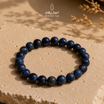 Blue Sapphire bracelet with 6 mm beads displayed on a natural stone surface