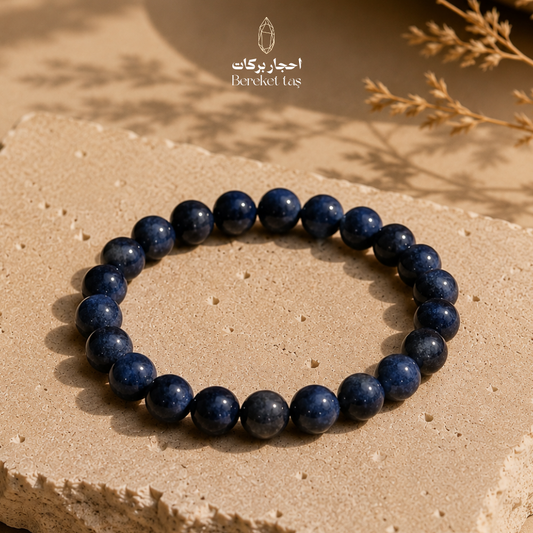 Blue Sapphire bracelet with 6 mm beads displayed on a natural stone surface