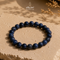 Blue Sapphire bracelet with 6 mm beads displayed on a natural stone surface