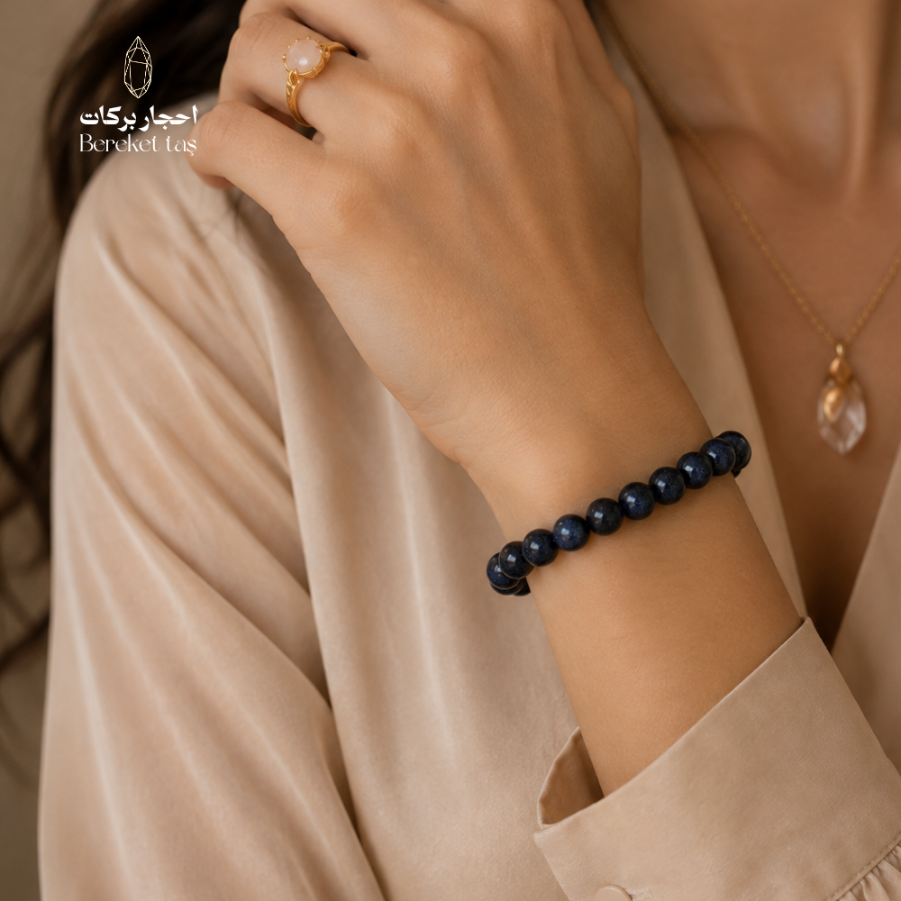 Blue Sapphire beaded bracelet with 6 mm stones styled on the wrist with an elegant beige outfit