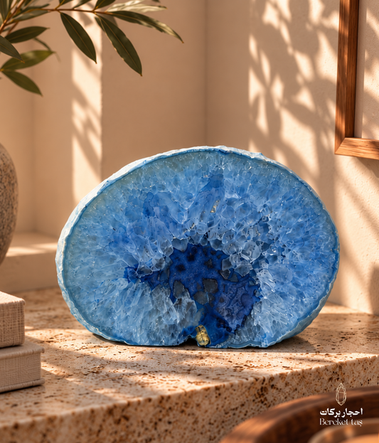 Brazilian blue agate decorative stone displayed on a travertine table