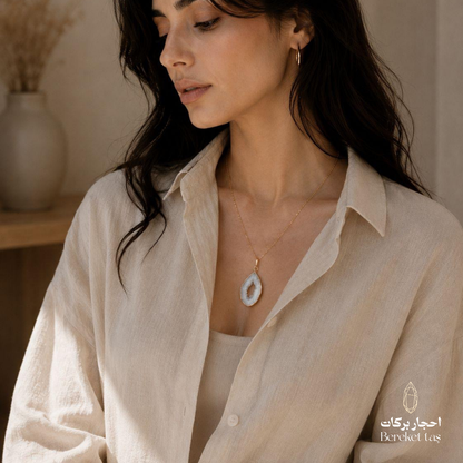 Natural Chalcedony pendant necklace with a gold-plated chain styled with an elegant neutral outfit
