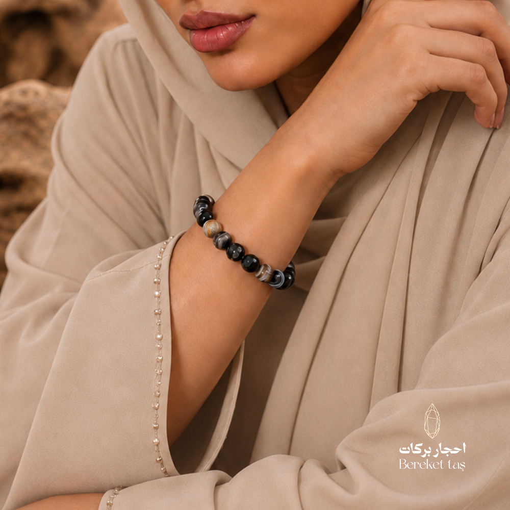 Eye Agate stone bracelet worn on the wrist with black and natural brown tones and distinctive natural patterns