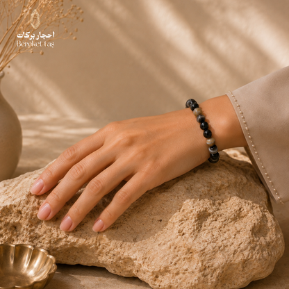 Eye Agate stone bracelet worn on the wrist, featuring black and brown tones with unique natural patterns