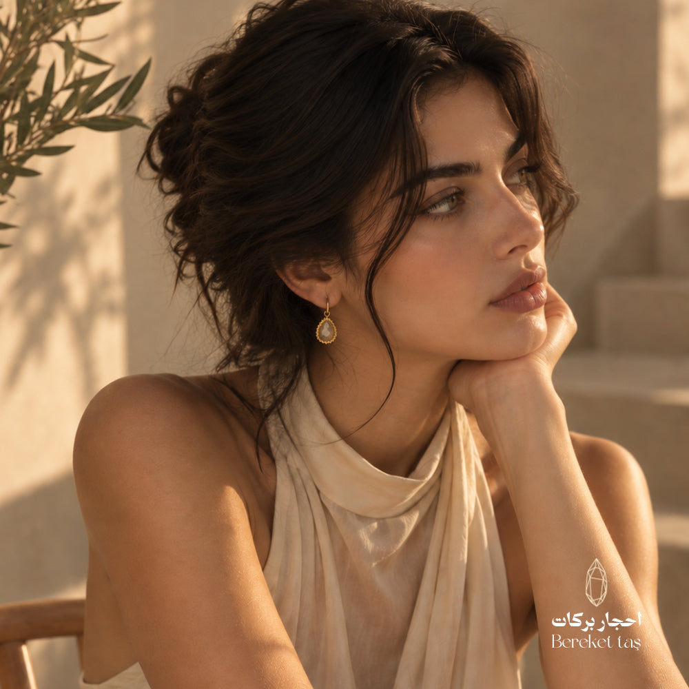 Elegant look featuring a natural Golden Rutilated Quartz teardrop earring with a gold-plated frame