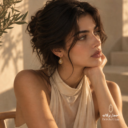 Elegant look featuring a natural Golden Rutilated Quartz teardrop earring with a gold-plated frame
