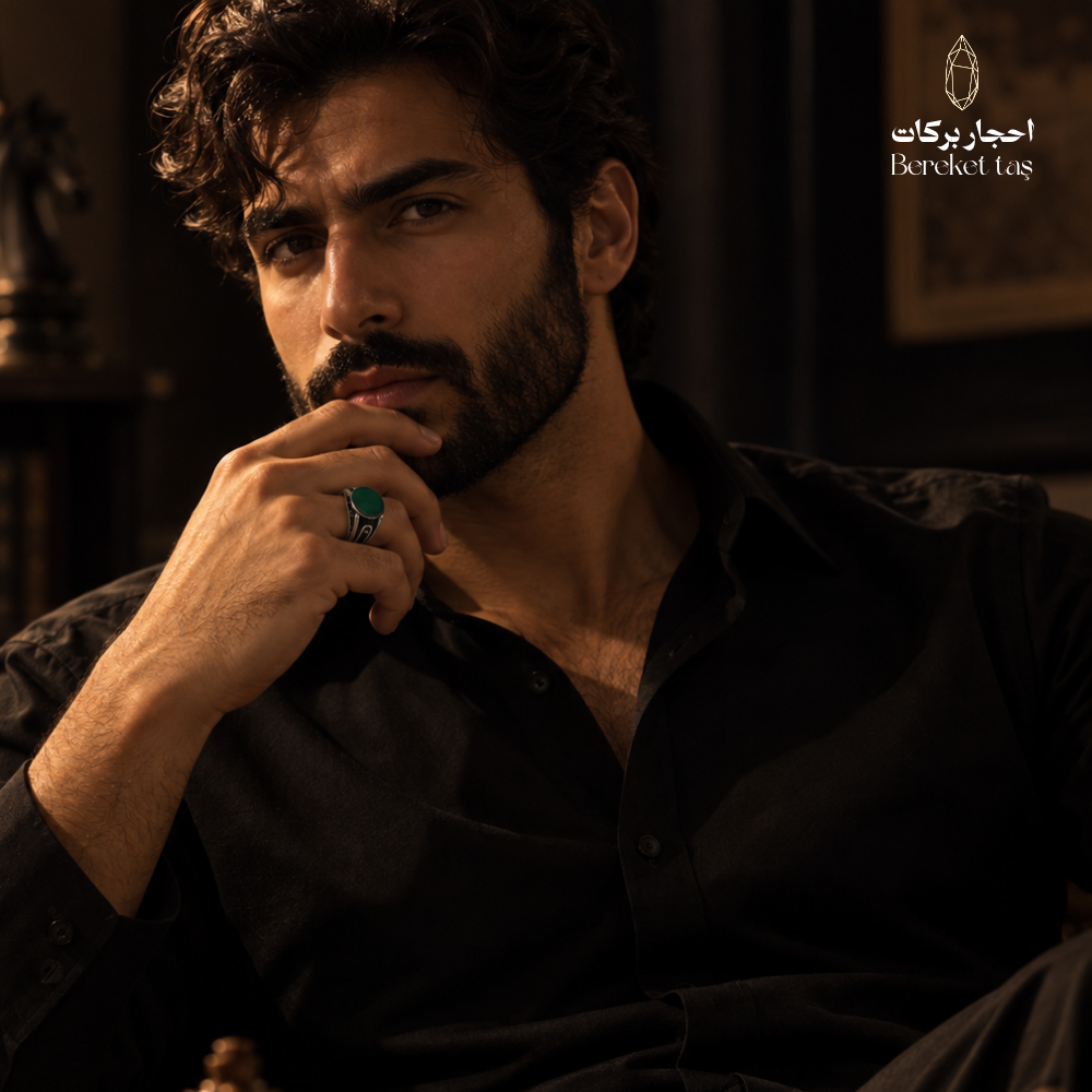 Man wearing a natural Green Agate ring in 925 Sterling Silver, styled with a black shirt in an elegant men's jewelry portrait.