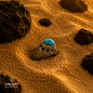 Handmade Iranian Nishapur turquoise ring in 925 sterling silver displayed on warm desert sand