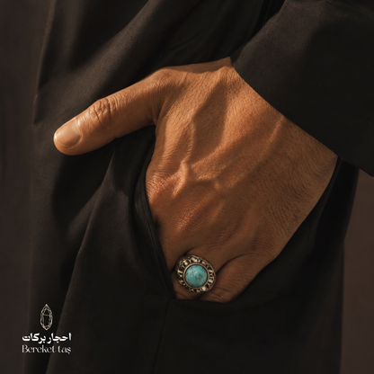 Man wearing a handmade Iranian Nishapur turquoise ring in 925 sterling silver