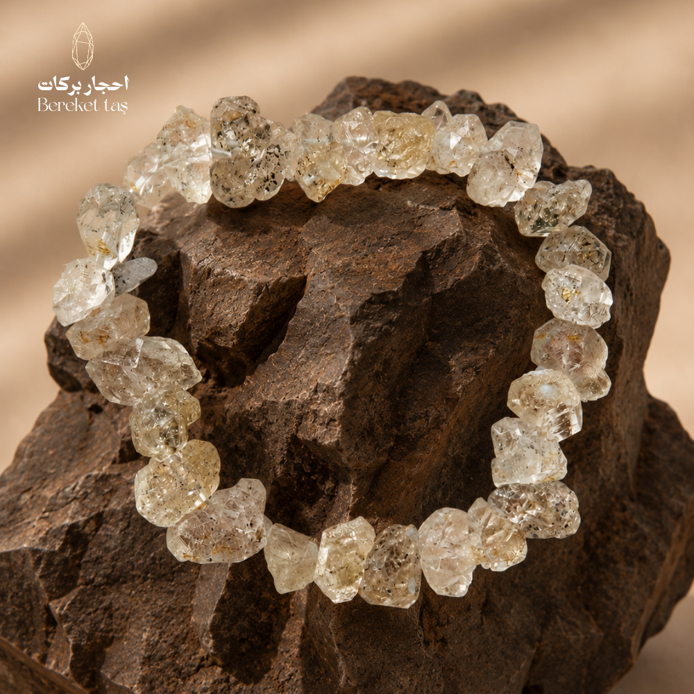 Natural Herkimer Quartz bracelet with raw crystal-shaped beads displayed on a dark stone