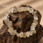 Natural Herkimer Quartz bracelet with raw crystal-shaped beads displayed on a dark stone
