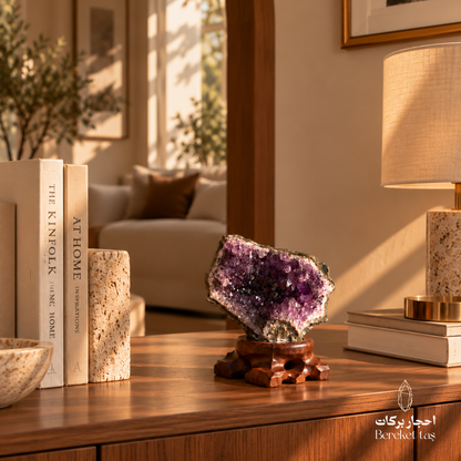 Natural Brazilian Amethyst stone displayed on a wooden stand in a warm home interior