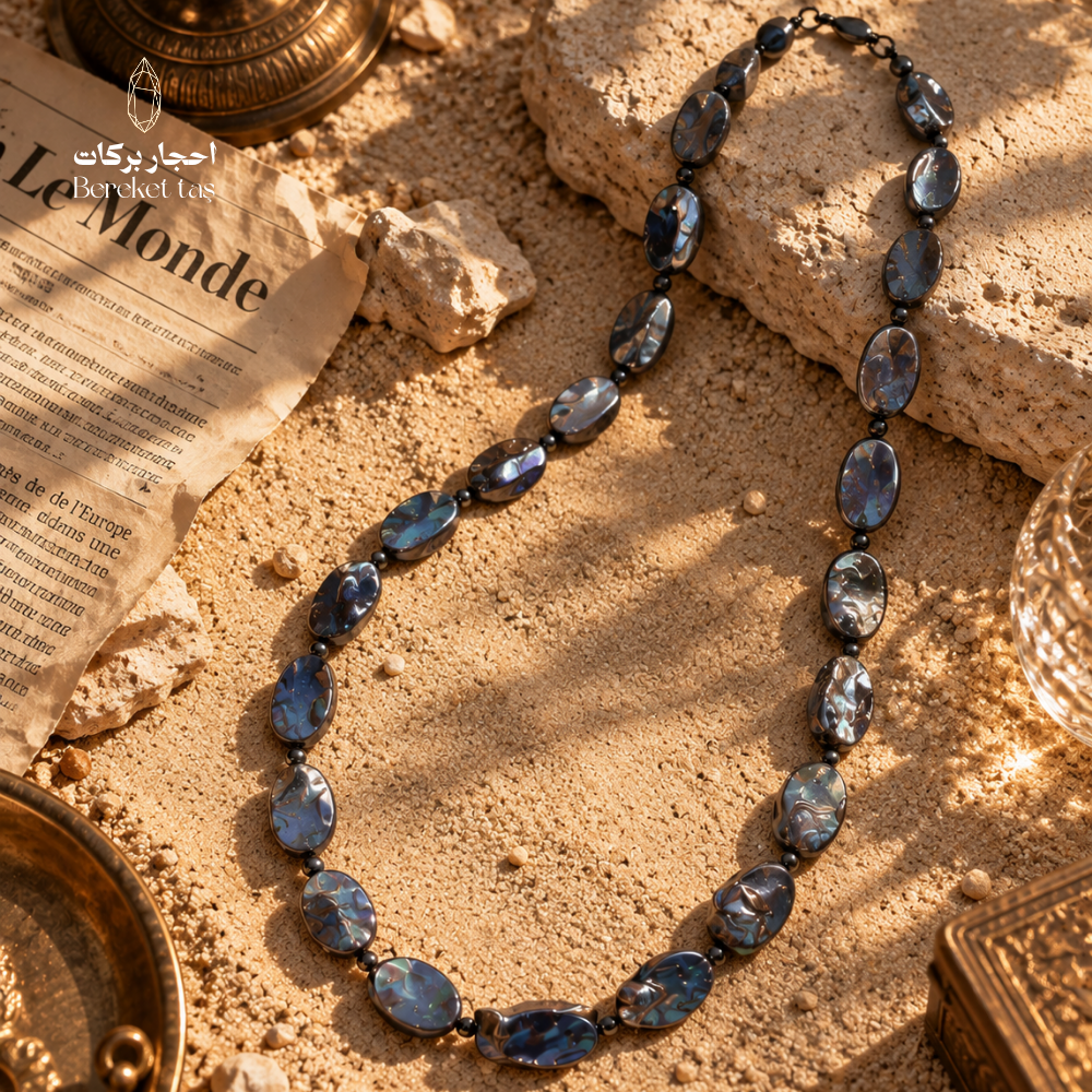 Natural gray Pearl handmade necklace with irregular beads showing subtle blue reflections on a warm textured surface