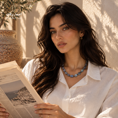 Natural gray Pearl handmade necklace styled with an elegant white outfit in a warm outdoor setting