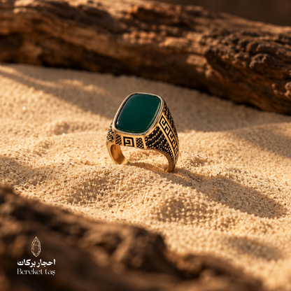 Natural green agate ring in 925 sterling silver displayed on warm sand with an elegant desert-inspired setting