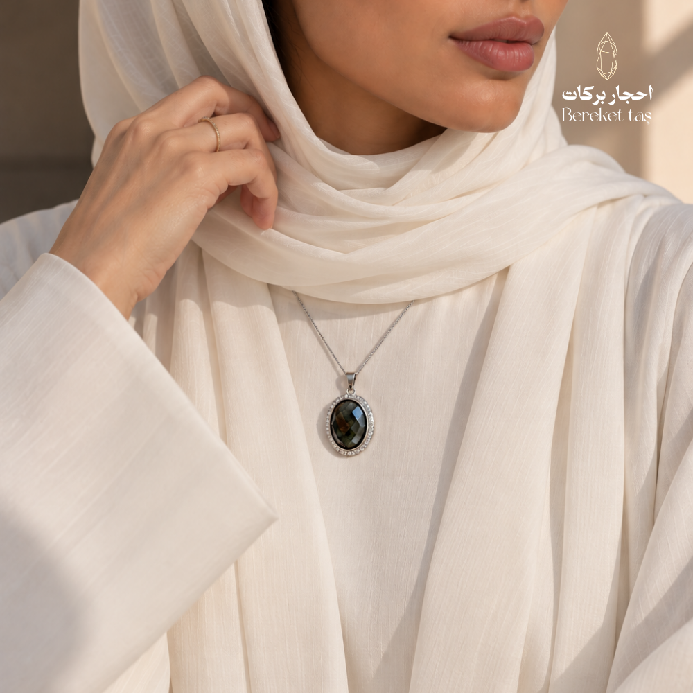 Natural Labradorite Peacock Stone pendant necklace with a silver chain styled with an elegant white outfit