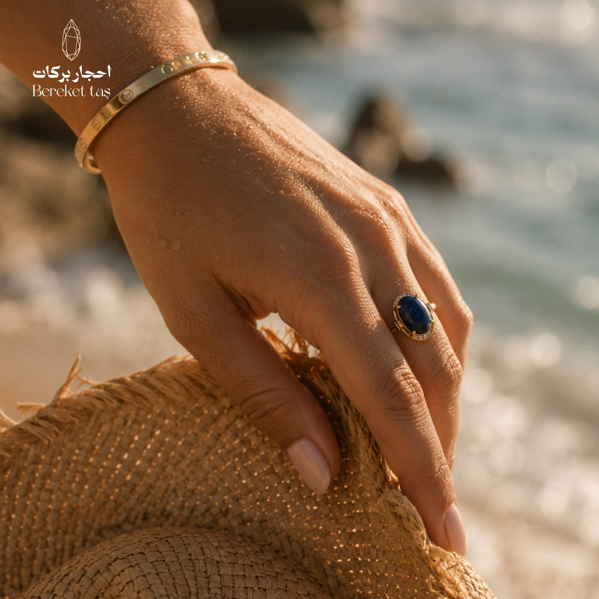 Natural Lapis Lazuli ring with a deep blue gemstone worn on the hand by the sea