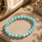 Natural Larimar stone bracelet in light blue with unique natural patterns and 12 mm beads