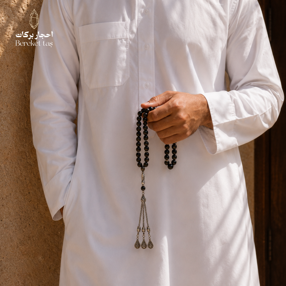 Natural black obsidian stone tasbih held by hand, 10 mm beads, by Bereket Taş