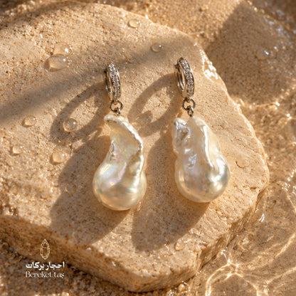 Close-up of handcrafted natural Pearl earrings with 925 sterling silver hoops