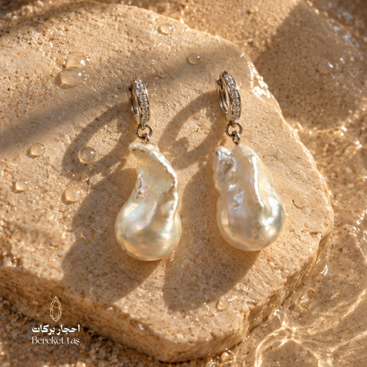 Close-up of handcrafted natural Pearl earrings with 925 sterling silver hoops