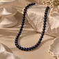 Natural Pearl beaded necklace with deep navy and black tones displayed on an elegant neutral surface