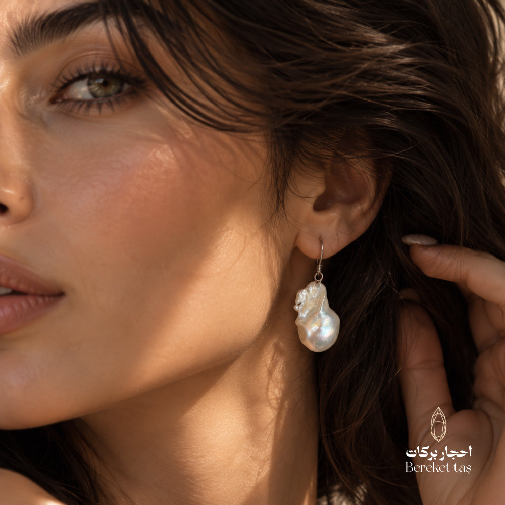 Close-up of a natural Pearl drop earring with 925 sterling silver hook