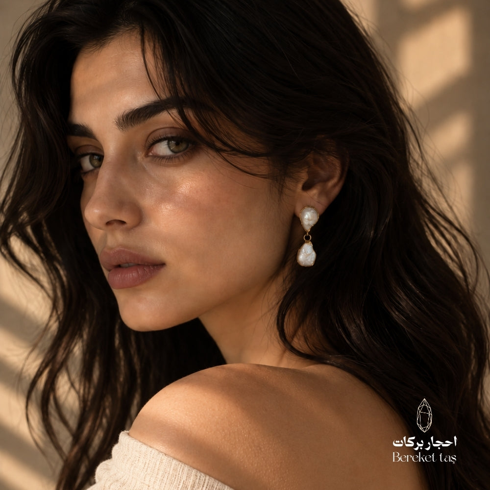 Elegant profile view featuring natural Pearl drop earrings with gold-plated metal