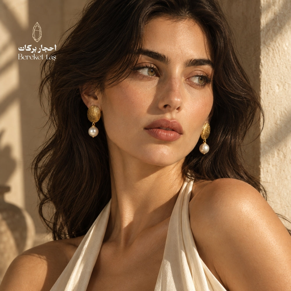 Woman wearing handcrafted natural Pearl earrings with gold-plated copper in an elegant look